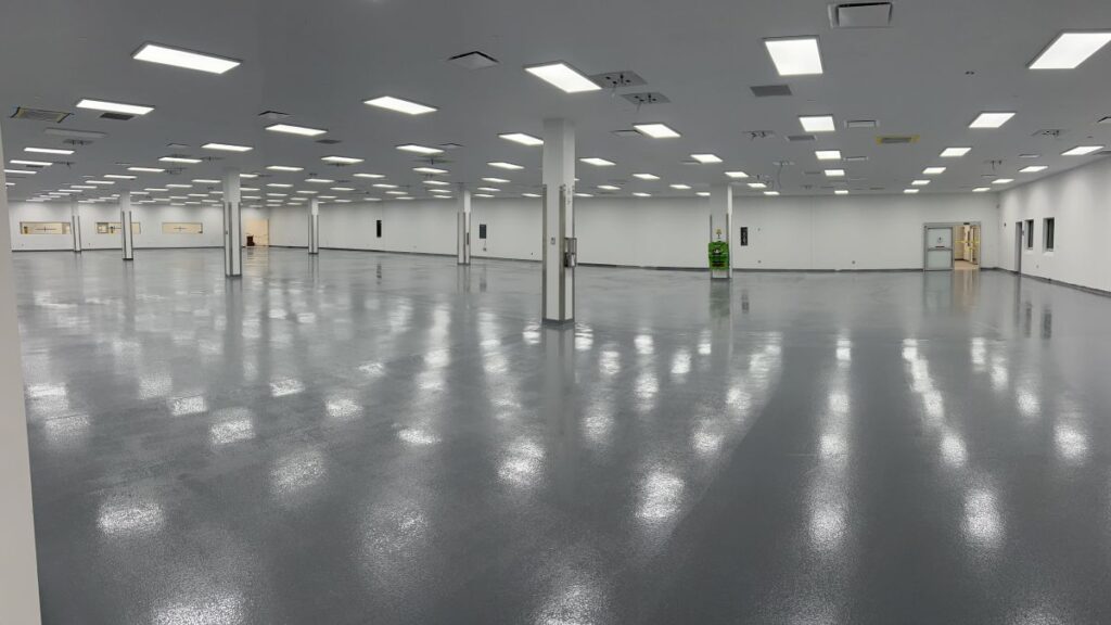 Industrial grey epoxy flooring installed in a North Jersey warehouse facility with high-gloss finish.
