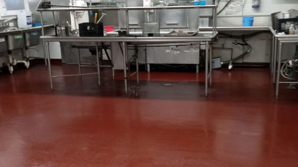 Commercial kitchen epoxy flooring installation in Jersey City, NJ featuring a seamless cove base